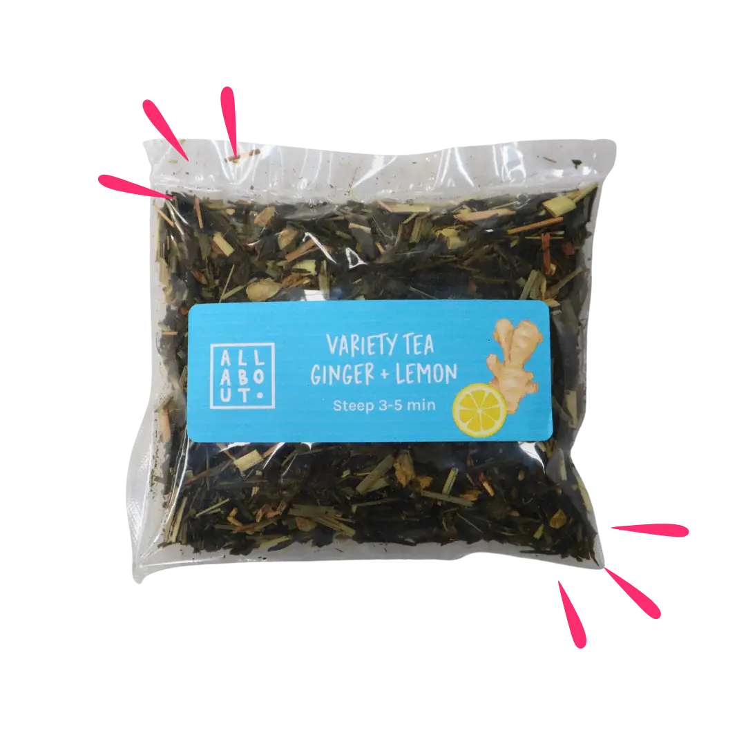 All About Kombucha variety tea pouch labeled Ginger + Lemon in a clear steeping pack with blue label, featuring ginger and lemon illustrations and loose herbal tea blend