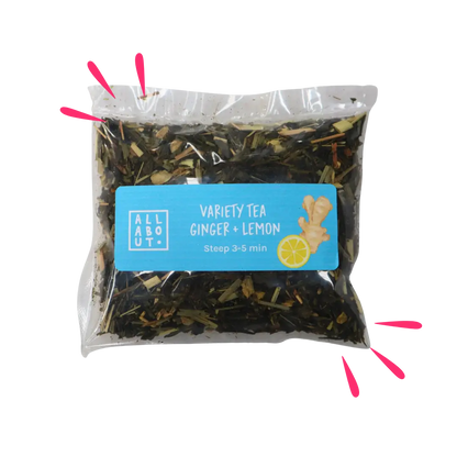 All About Kombucha variety tea pouch labeled Ginger + Lemon in a clear steeping pack with blue label, featuring ginger and lemon illustrations and loose herbal tea blend