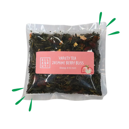 All About Kombucha variety tea pouch labeled Jasmine Berry Bliss in a clear 3–5 minute steeping pack with a pink label, containing loose tea leaves and dried berries.
