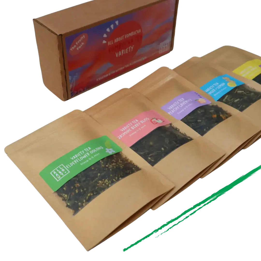 All About Kombucha tea variety pack featuring five kraft paper pouches of loose leaf tea blends, including elderflower oolong, berry bliss, and peach blossom, alongside branded packaging box